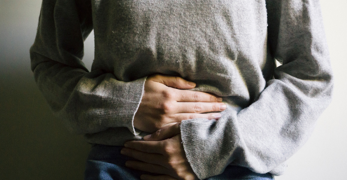 Woman-holding-her-abdomen-in-pain-from-neurogenic-bladder